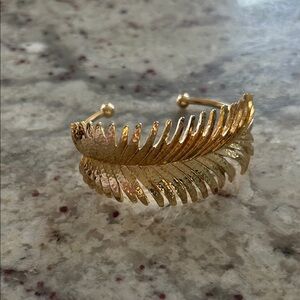 Gold Tone Open Cuff Bracelet with Feather Accent